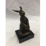 A SMALL BRONZE OF A RABBIT HOLDING FLOWERS ON MARBLE BASE SIGNED MILO H: 14CM