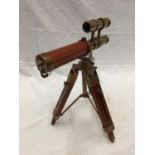 A SMALL BRASS AND LEATHER TELESCOPE ON WOODEN TRIPOD STAND H: 30CM