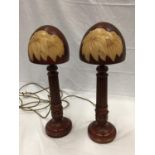 A PAIR OF UNUSUAL LAMPS WITH WOODEN COLUMN STYLE BASES AND MUSHROOM STYLE SHADES H: 48CM