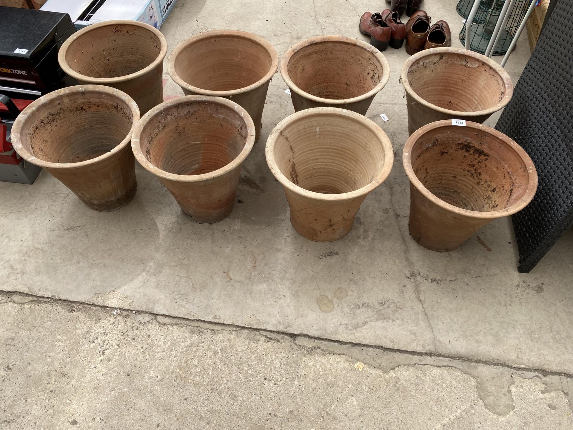 A COLLECTION OF EIGHT LARGE TERRACOTTA GARDEN POTS