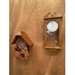 A WOODEN VIENNA STYLE WALL CLOCK AND A MODERN CUCKOO CLOCK