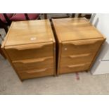A PAIR OF RETRO OAK BEDSIDE CHESTS OF THREE DRAWERS
