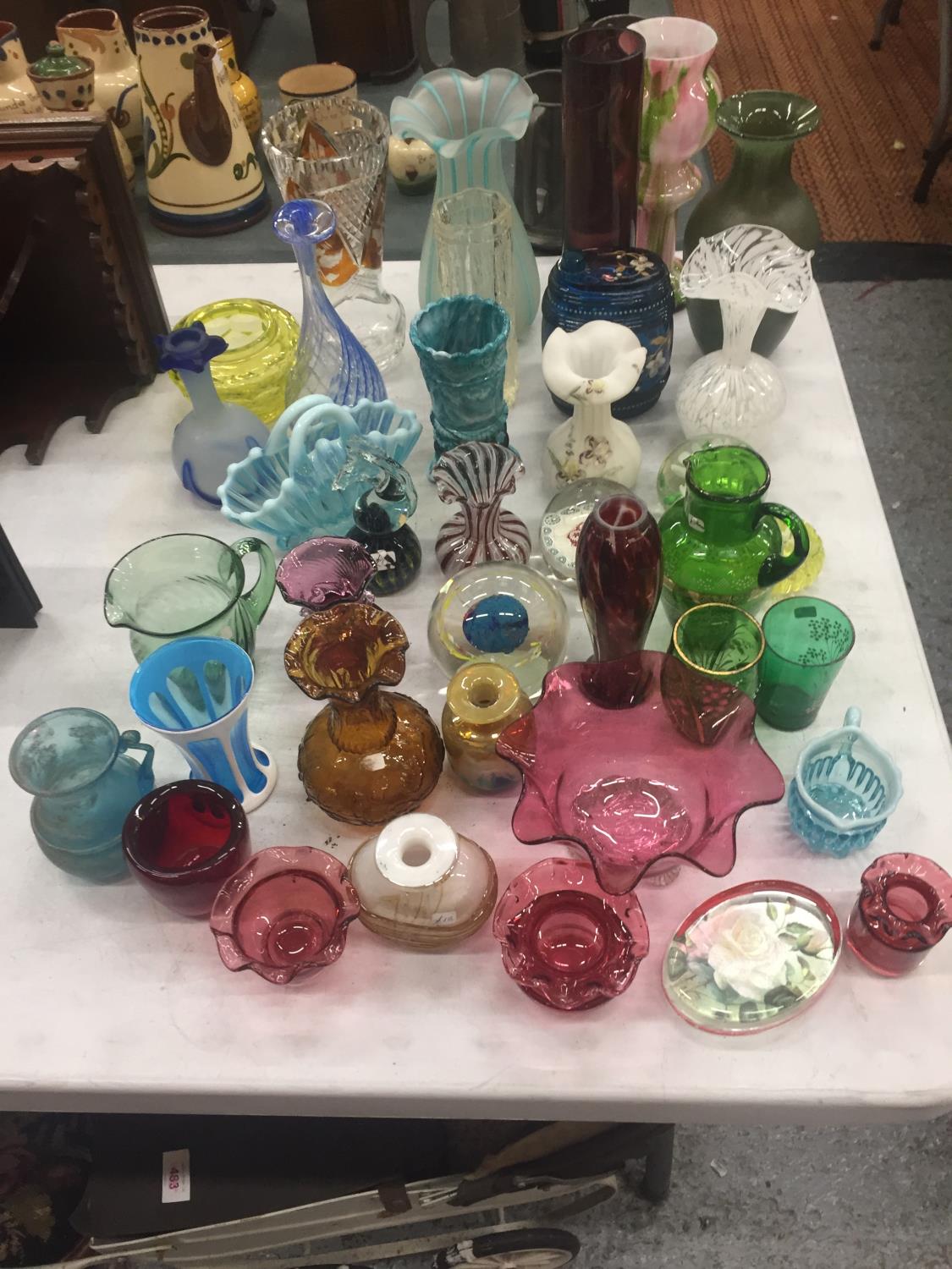 A LARGE QUANTITY OF COLOURED STUDIO ART GLASSWARE TO INCLUDE BOWLS, VASES, PAPERWEIGHTS, ETC