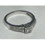 A 9 CARAT WHITE GOLD RING WITH CENTRE DIAMOND AND ON SHOULDERS SIZE K/L