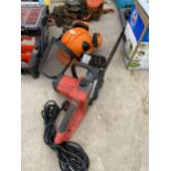 AN ELECTRIC CHAINSAW AND A SAFETY HAT WITH EAR DEFENDERS