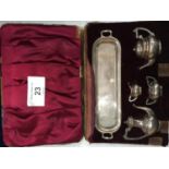 A SET OF BIRMINGHAM HALLMARKED SILVER MINIATURE TEAPOTS AND JUGS IN A CASE