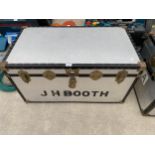 A METAL TRAVEL TRUNK WITH BRASS FITTINGS BEARING THE NAME 'J H BOOTH'