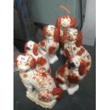 SIX RED AND WHITE STAFFORDSHIRE MANTLE SPANIEL DOGS