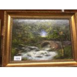 AN OIL ON BOARD OF A FLOWING STREAM, CHILDREN AND A BRIDGE 42CM X 32CM IN A GILT FRAME