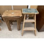 AN OAK NEST OF THREE TABLES AND FOLDING STEP STOOL