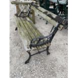 A WOODEN SLATTED GARDEN BENCH WITH CAST IRON BENCH ENDS