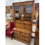 AN ERCOL COCKTAIL CABINET/BUREAU WITH GLAZED UPPER PORTION, 38.5" WIDE