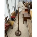 A MID 20TH CENTURY OAK STANDARD LAMP COMPLETE WITH SHADE