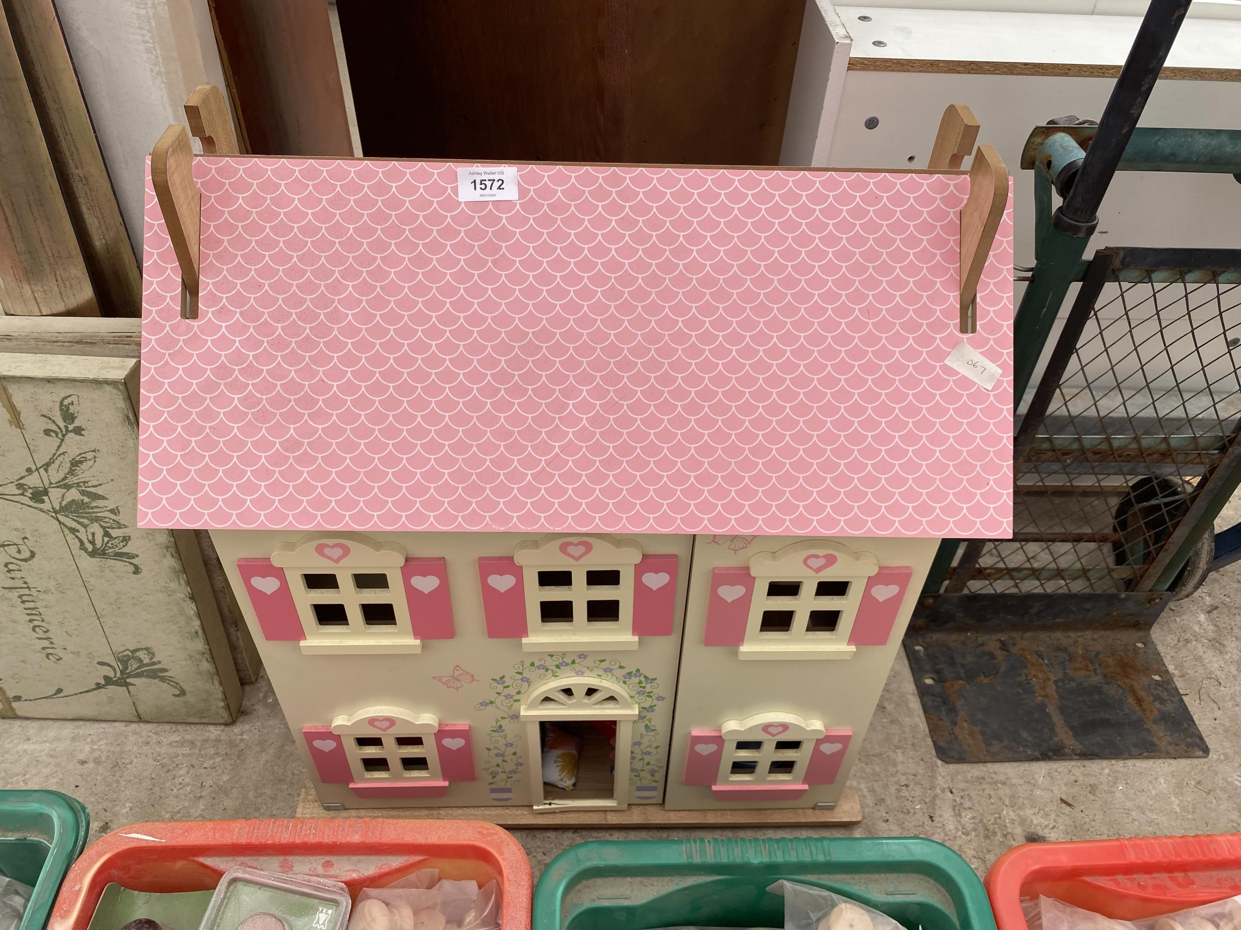 A PAINTED WOODEN DOLLS HOUSE