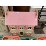 A PAINTED WOODEN DOLLS HOUSE