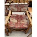 AN EARLY 20TH CENTURY OAK ELBOW CHAIR WITH SCROLL ARMS