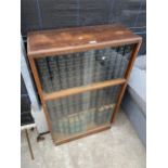 A MID 20TH CENTURY WALNUT BOOKCASE WITH SLIDING GLASS DOORS AND TWENTY-SEVEN ENCYCLOPEDIA