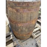 A VINTAGE OAK AND METAL BANDED WHISKEY BARREL