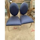 A PAIR OF CHROME FRAMED DINING CHAIRS ON TAPERED LEGS WITH OVAL BACKS