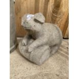 A RECONSTITUTED STONE GARDEN PIG FIGURE