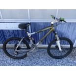 A SILVERFOX KNARLY MOUNTAIN BIKE WITH FRONT SUSPENSION AND 24 SPEED GEAR SYSTEM