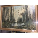 A FRAMED OIL ON CANVAS OF A WOODLAND LAKE 83CM X 58CM