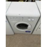 A WHITE INDESIT WASHING MACHINE