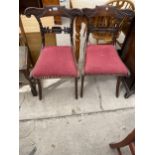 A PAIR OF REGENCY SIMULATED ROSEWOOD DINING CHAIRS ON SABRE LEGS, WITH CARVED FOLIATE BACKS