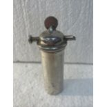 A WHITE METAL PERFUME CANISTER