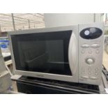 A SILVER SAMSUNG MICROWAVE OVEN