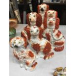 SIX RED AND WHITE STAFFORDSHIRE MANTLE DOGS OF VARYING SIZES