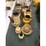 A COLLECTION OF MOTTO WARE TO INCLUDE JUGS, CUP AND SAUCER, ETC
