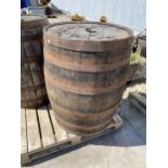 A VINTAGE OAK AND METAL BANDED WHISKEY BARREL