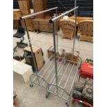A PAIR OF METAL CLOTHES RAILS WITH LOWER SHELVES