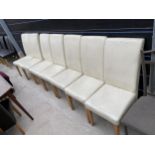 A SET OF SEVEN WHITE FAUX LEATHER DINING CHAIRS