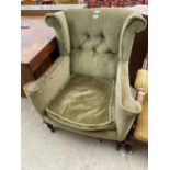 AN EDWARDIAN WINGED FIRESIDE CHAIR WITH BUTTON-BACK, ON FRONT CABRIOLE LEGS