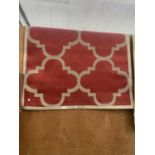A MODERN RED PATTERNED RUG