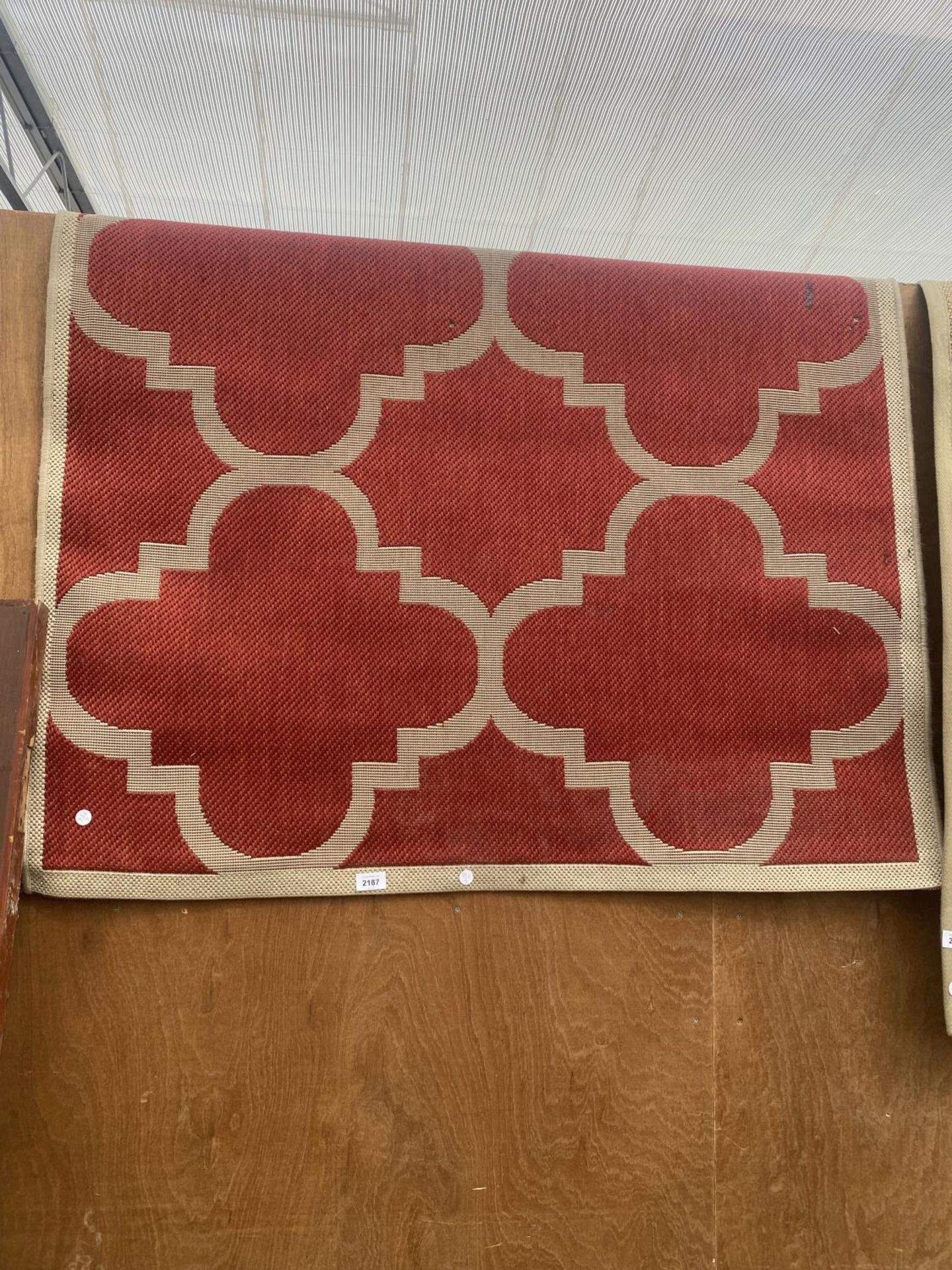 A MODERN RED PATTERNED RUG