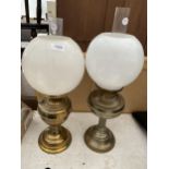 A NEAR PAIR OF BRASS OIL LAMPS WITH GLASS SHADES