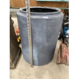 A ROUND GREY GARDEN PLANTER