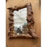 A DECORATIVE DRIFT WOOD FRAMED WALL MIRROR