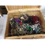 A WICKER PICNIC BASKET CONTAINING A QUANTITY OF COSTUME JEWELLERY TO INCLUDE BANGLES, NECKLACES,