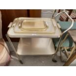 A METALWARE TWO TIER TROLLEY AND WOODMET, CAREFREE AND ONE OTHER TRAY