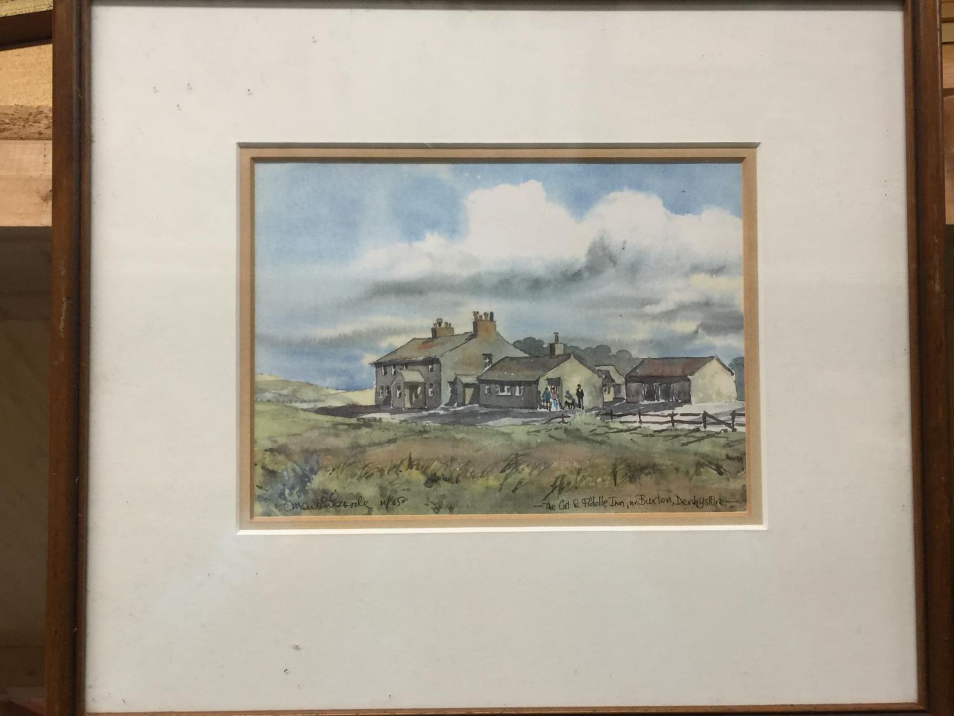 A PAIR OF FRAMED WATERCOLOURS OF HATHERSAGE AND THE CAT AND FIDDLE INN IN BUXTON - 32 X 28 CM TO