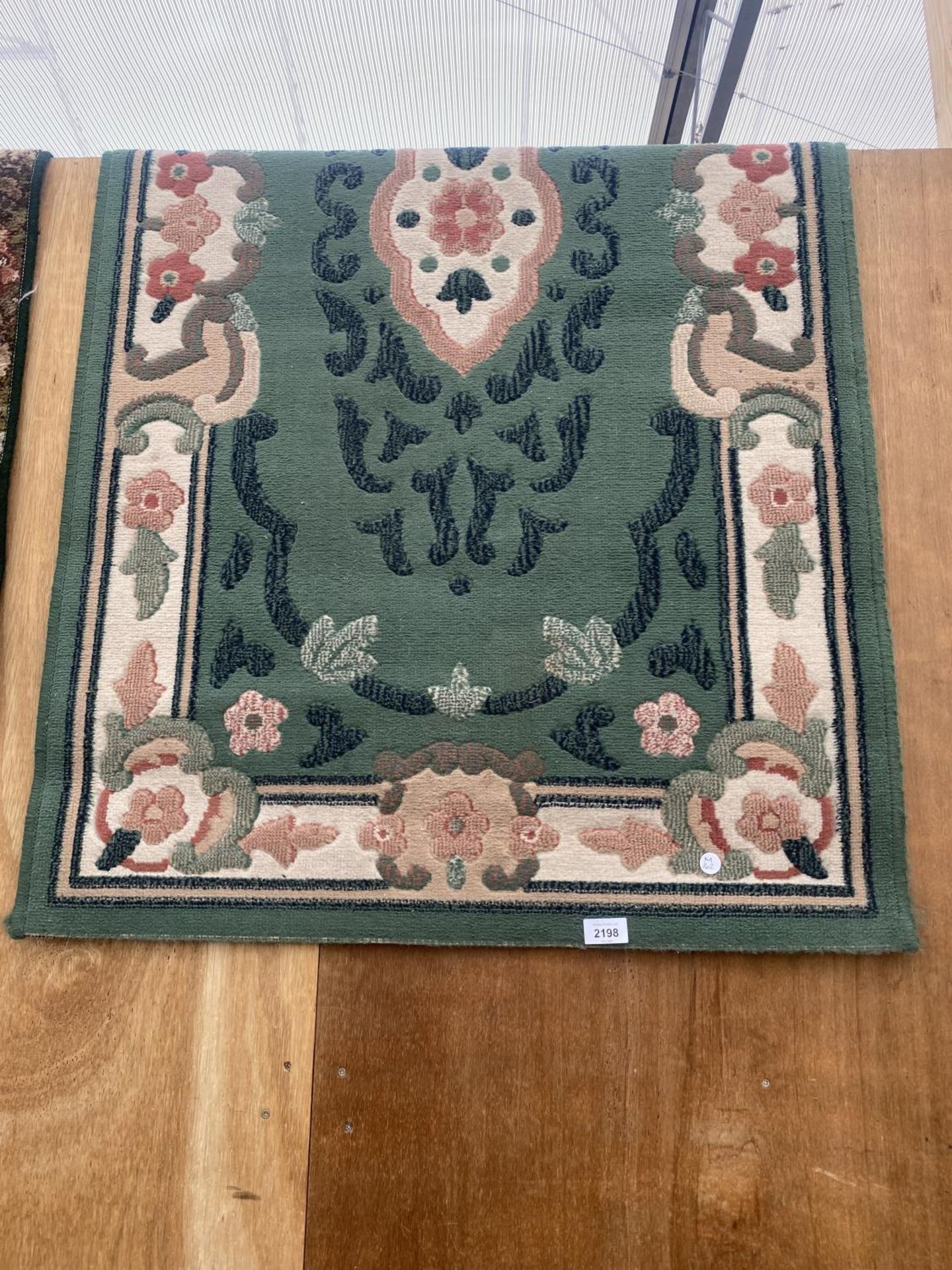 A GREEN PATTERNED RUG