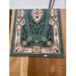 A GREEN PATTERNED RUG