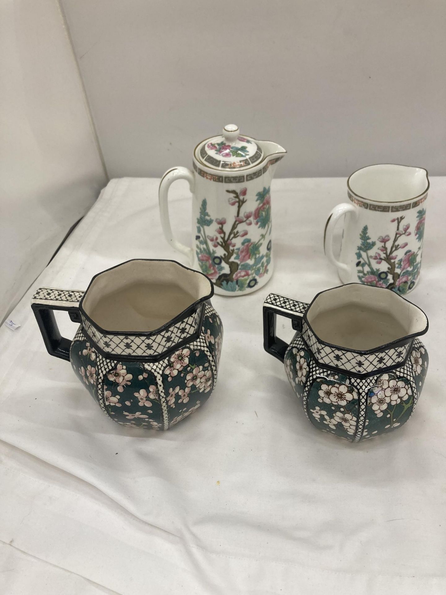 TWO GRADUATED VINTAGE ROYAL DOULTON JUGS REG NO. 597783, PATTERN NO. D3833 - A/F SMALL CHIP TO ONE