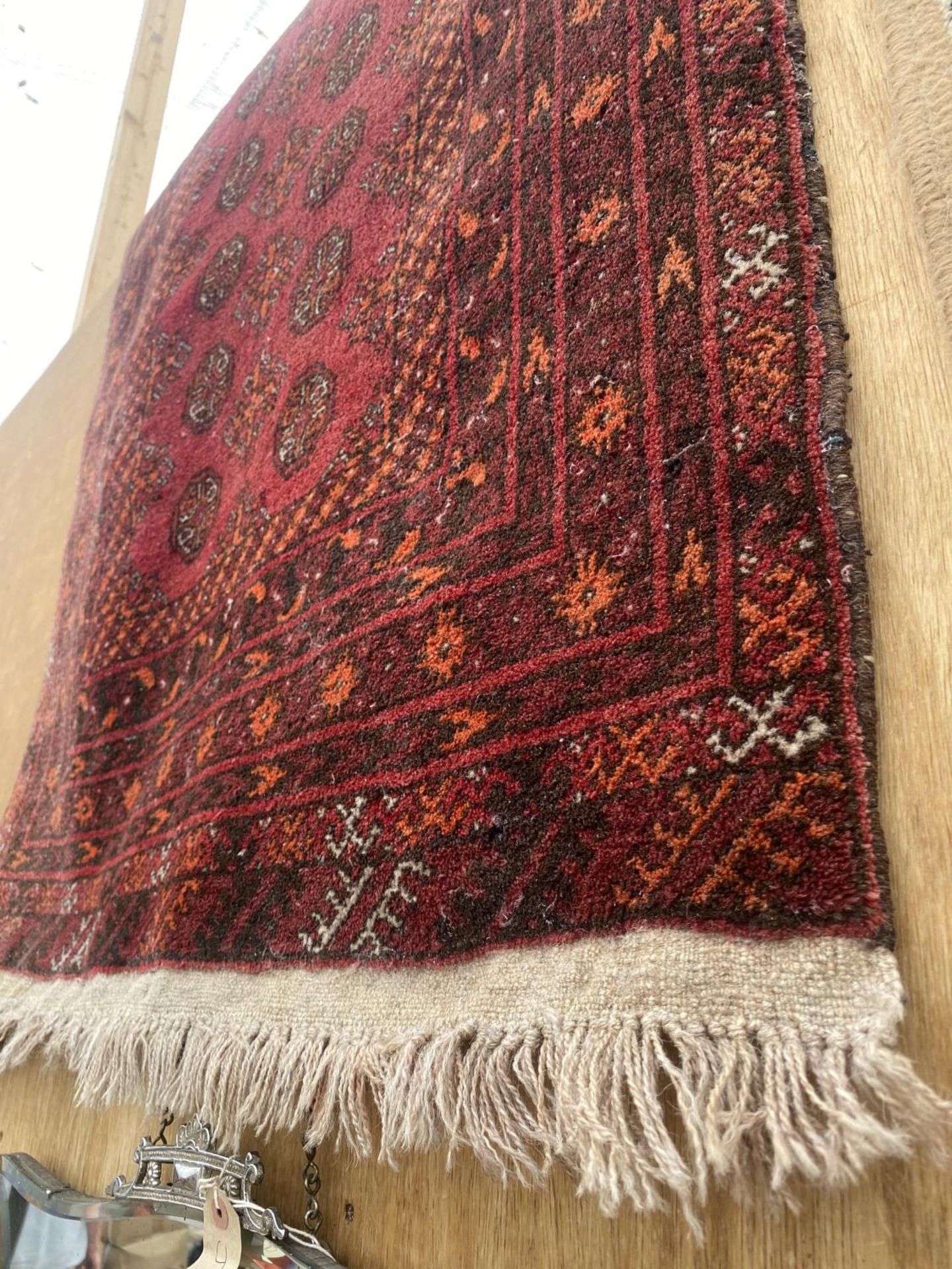 A RED PATTERNED FRINGED RUG - Image 2 of 3
