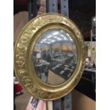 A GILT FRAMED VINTAGE CONCAVE MIRROR