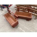 A PAIR OF WOODEN TROUGH PLANTERS WITH PLASTIC INSERTS